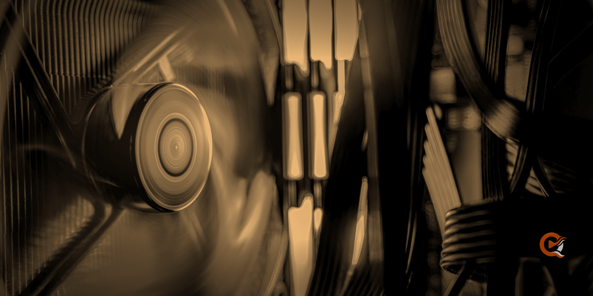 Close-up of a computer cooling fan spinning inside a case, lit in amber